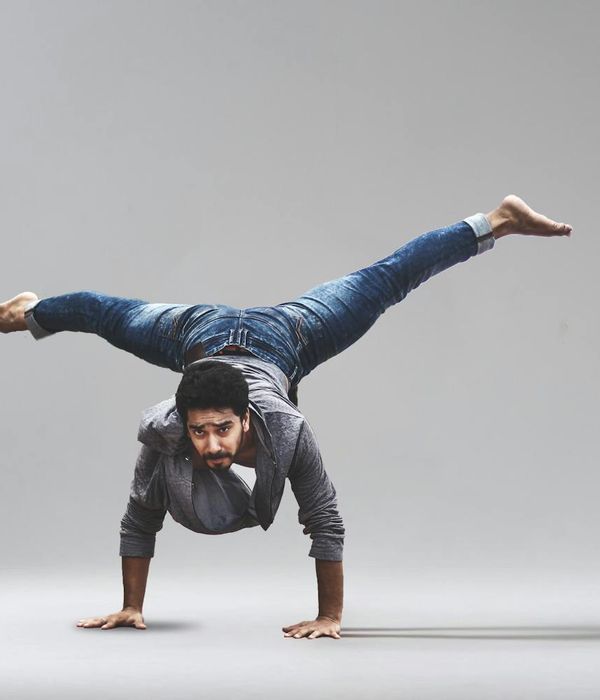 Man performing a functional strength exercise with focused expression.